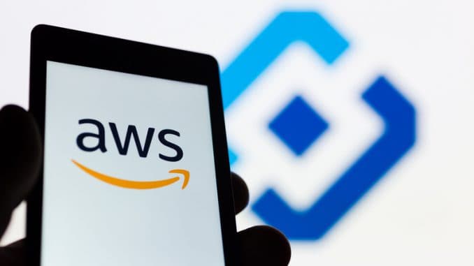 Smartphone in hand with Amazon Web Services AWS logo.