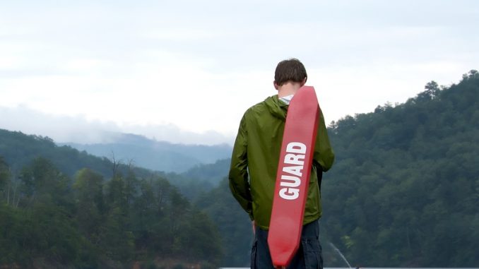 A life guard watches for trouble at the lake.