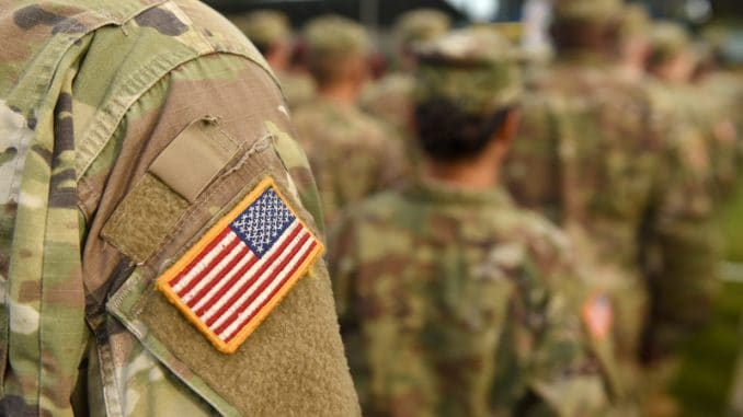 American Soldiers and Flag of USA on soldiers arm. US Army. Veteran Day.